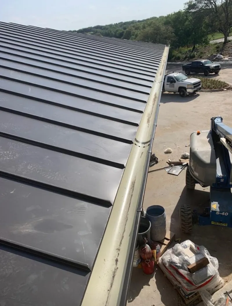 Standing seam panel and gutter detail on a metal roofing jobsite in Wilmington Island
